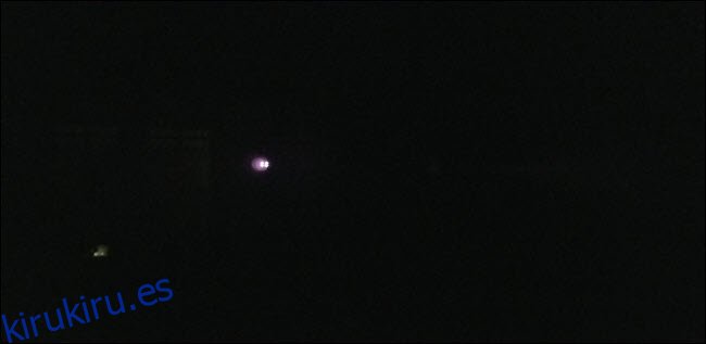 Una imagen oscurecida con luces brillantes visibles en la distancia.