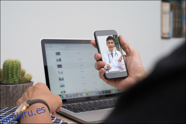 Un hombre que se comunica con un médico a través de un chat de video en un teléfono inteligente.