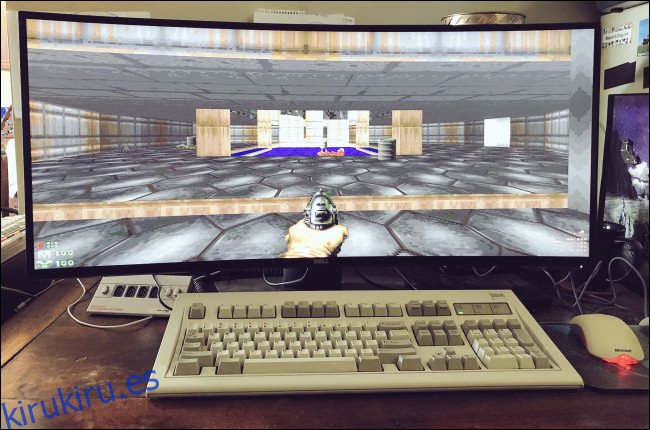 GZDoom en un monitor de pantalla ancha detrás de un teclado y un mouse de escritorio. 